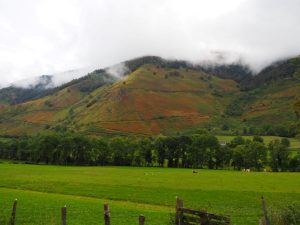 8. Naast de akkers zien we bergen met herfstkleuren, gevangen in wolken